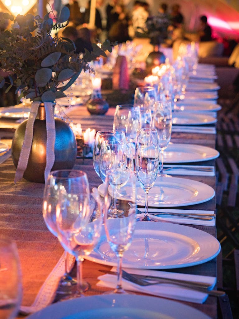 A beautifully set dinner table with candles and glassware, perfect for elegant events.